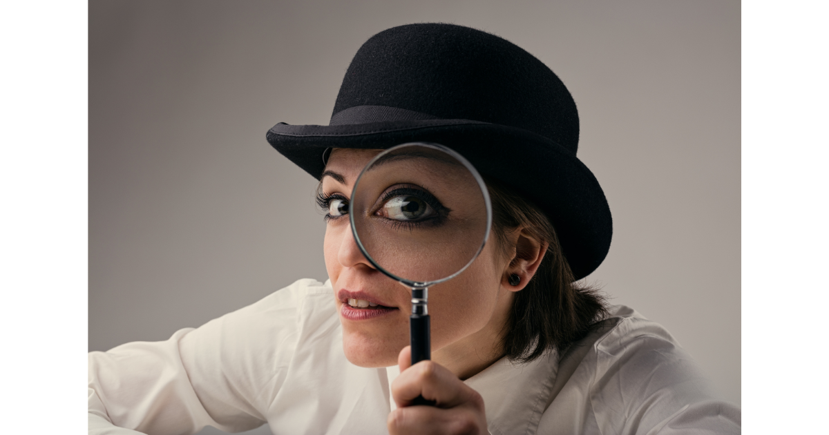 Woman looking through magnifying glass at you, the reader